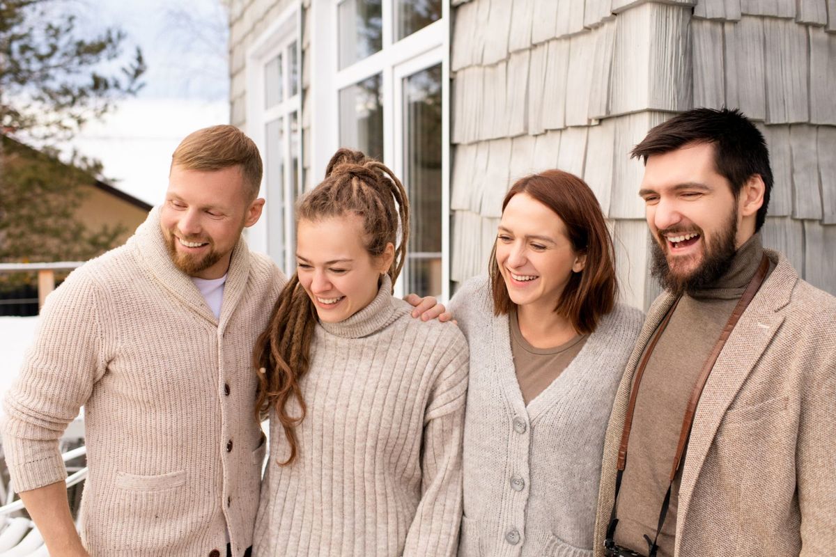Neighbors laughing together in front of a house